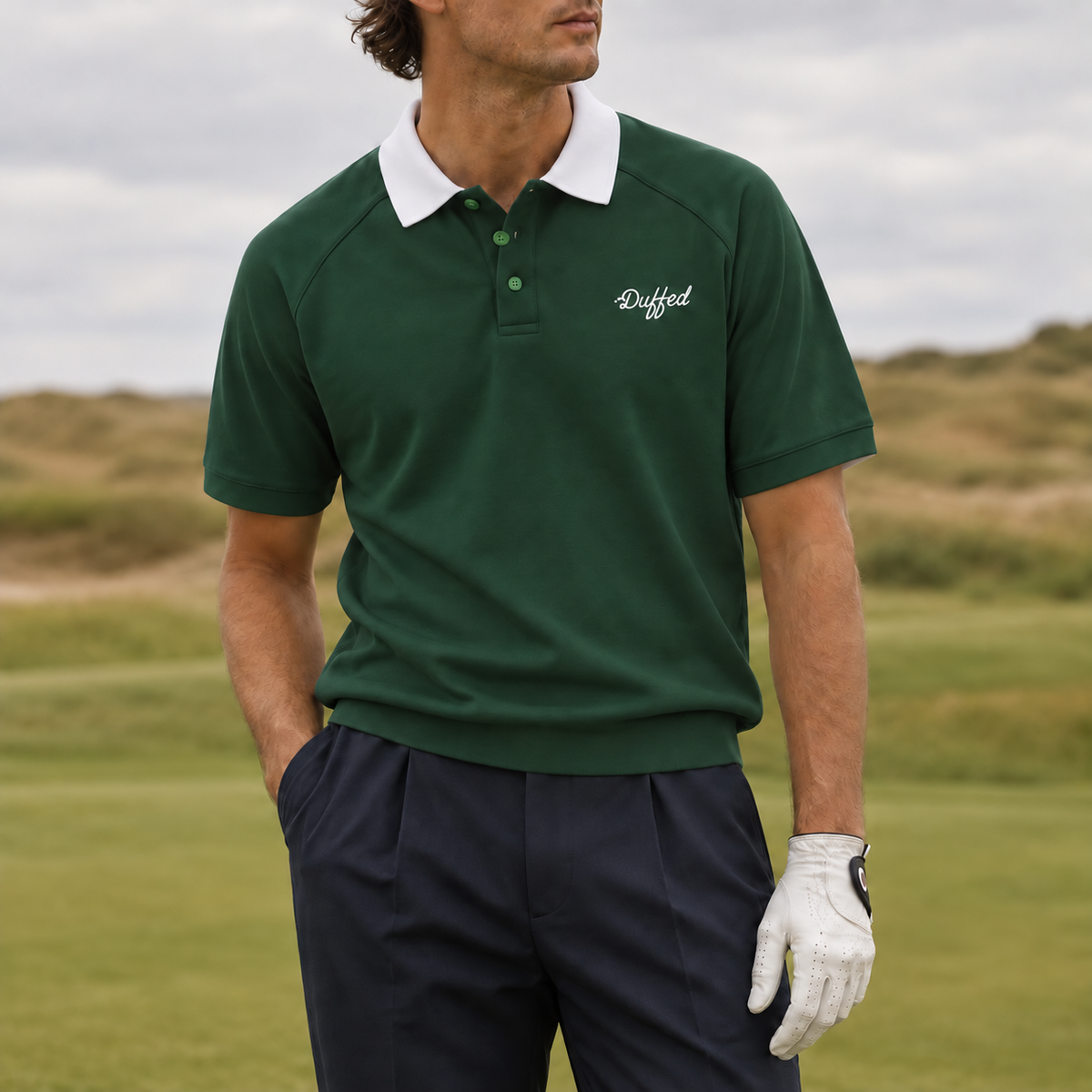 Duffed dark green contrast-collar raglan polo on a golfer at the links course