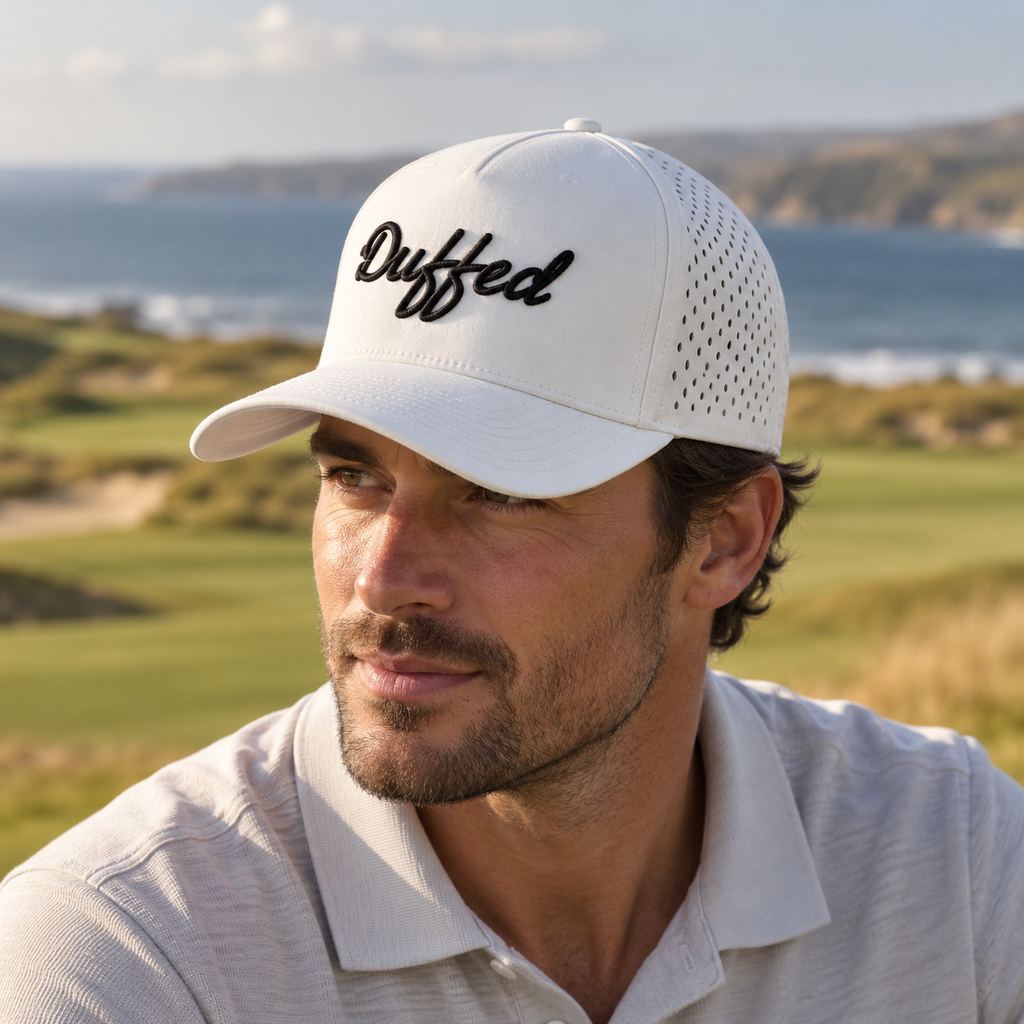 Duffed Chalk Script Performance Cap — close-up coastal golf lifestyle photograph