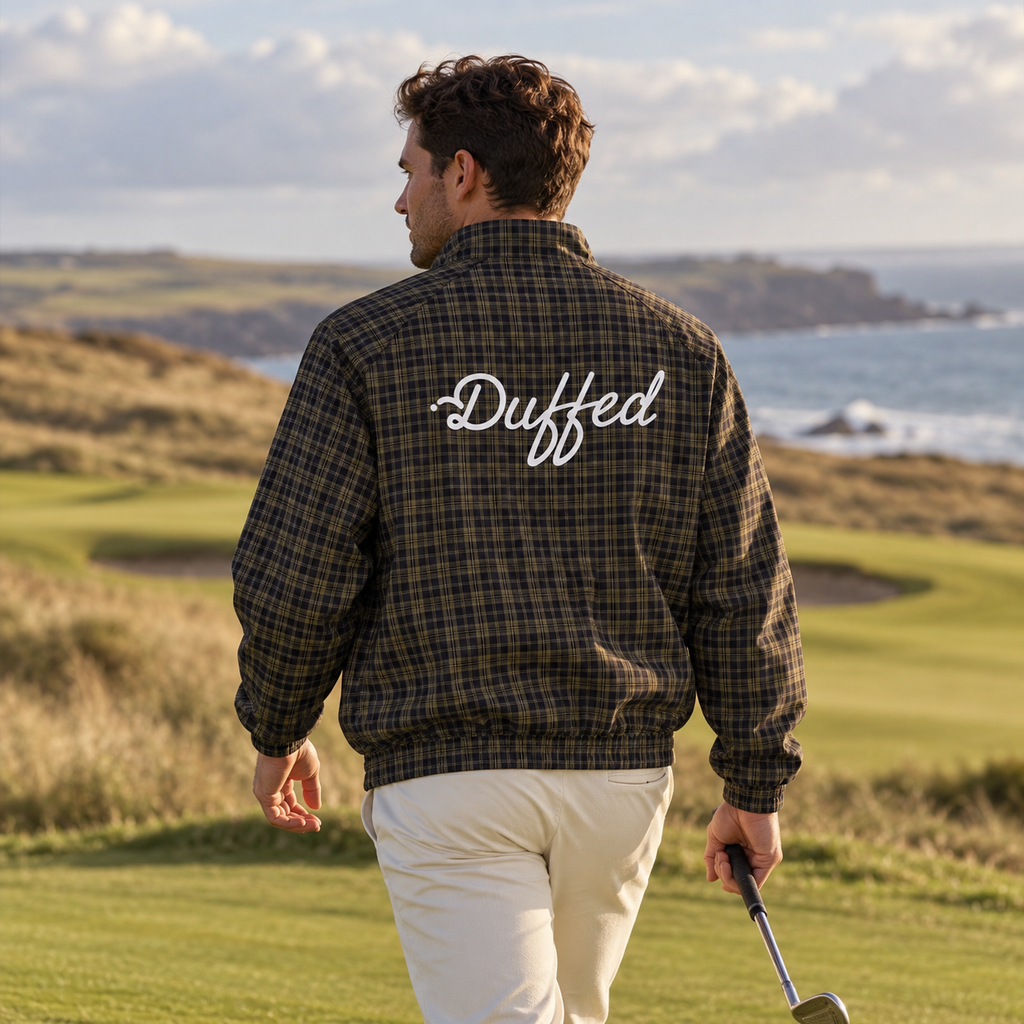 Golfer wearing the Duffed Links Plaid Track Jacket on a coastal links course