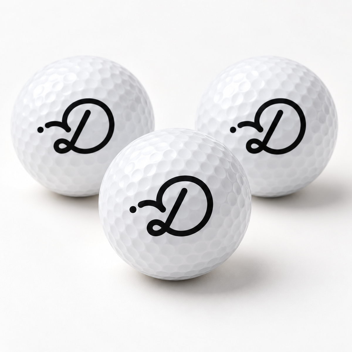 White Duffed golf balls with black D monogram